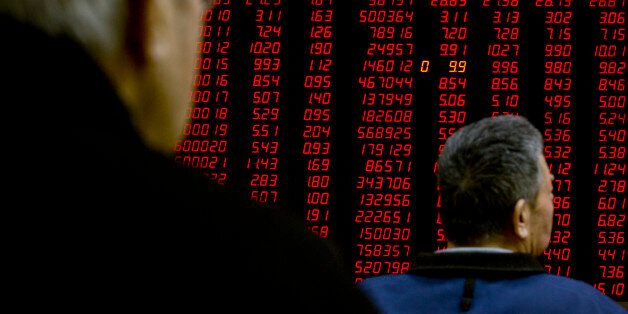 Chinese investors monitor stock prices on an electronic display in a brokerage house in Beijing, Friday, Jan. 22, 2016. Japan led a rally in Asian stocks Friday, extending a global market rebound fueled by the prospect of more stimulus from the European Central Bank and a bounce in battered oil prices. (AP Photo/Mark Schiefelbein)