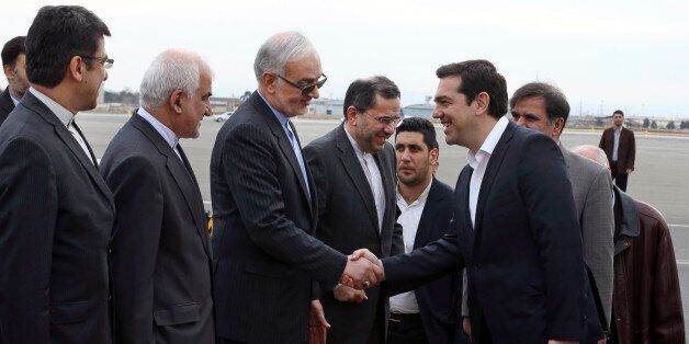 Greek Prime Minister, Alexis Tsipras, fourth right, is welcomed by Iranian officials upon his arrival to Mehrabad Airport, Tehran, Iran, Sunday, Feb. 7, 2016. (AP Photo/Vahid Salemi)