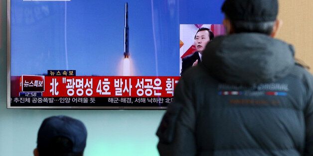 People watch a television screen showing a news broadcast on North Korea's long-range rocket launch at Seoul Station in Seoul, South Korea, on Sunday, Feb. 7, 2016. North Korea launched a long-range rocket Sunday, just weeks after conducting a fourth nuclear test in the latest setback for international efforts to pressure the Kim Jong Un regime to end its weapons program. Photographer: SeongJoon Cho/Bloomberg via Getty Images