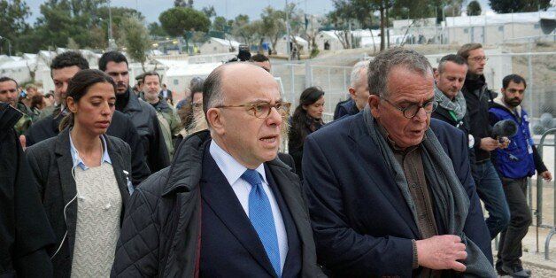 French Interior Minister Bernard Cazeneuve (C) is guided by the Greek Junior Interior Minister for Migration Ioannis Mouzalas at the 'Hot Spot' in Moria , on the the northern Greek Aegean island of Lesbos, on February 4, 2016. Cazeneuve warned against 'a risk to Schengen' if Europeans fail to move forward on the control of external borders during his visit to the island where many of the refugees and migrants arrive after crossing the sea from Turkey. He also assured the Greeks of the French government's 'solidarity'. / AFP / STR (Photo credit should read STR/AFP/Getty Images)