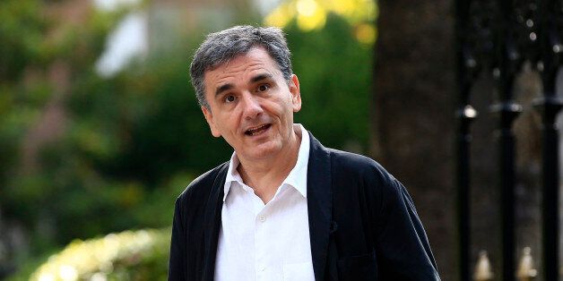 Greece's Finance Minister Euclid Tsakalotos reacts as journalists ask for a statement after new cabinet's swearing in ceremony at the presidential palace in Athens, Wednesday, Sept. 23, 2015. Greece's newly re-elected left-wing government has retained Euclid Tsakalotos as finance minister to continue tough negotiations with other eurozone countries on the terms of a large new bailout deal. (AP Photo/Lefteris Pitarakis)