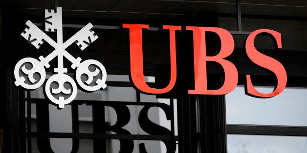 A picture taken on on January 12, 2016 shows the logo of the Swiss global financial services company UBS at the entrance of a branch's building in Zurich. / AFP / FABRICE COFFRINI (Photo credit should read FABRICE COFFRINI/AFP/Getty Images)