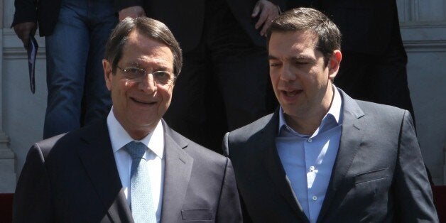 ATHENS, GREECE APRIL 17: Greece's President Alexis Tsipras (R) welcomes Greek Cypriot leader Nicos Anastasiadis (L) during Anastasiadis's visit, in Athenrs, Greece on April 17, 2015. (Photo by Ayhan Mehmet/Anadolu Agency/Getty Images)