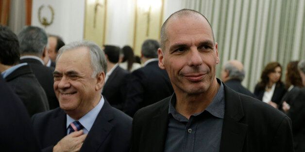 New Greek Finance Minister Yanis Varoufakis, right, and Deputy Prime Minister Giannis Dragasakis, left, smile after a swearing in ceremony at the Presidential Palace in Athens, Tuesday, Jan. 27, 2015. Greece's new left-wing Prime Minister Alexis Tsipras picked an outspoken bailout critic, Yanis Varoufakis, as his new finance minister Tuesday, signaling his revolve to take a tough line with eurozone lenders in an effort to write off a massive chunk rescue debt. (AP Photo/Thanassis Stavrakis)