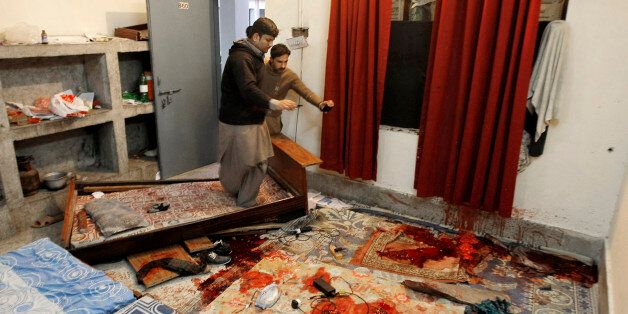 Pakistani students look at a room inside a hostel following the attack at Bacha Khan University in Charsadda town, some 35 kilometers (21 miles) outside the city of Peshawar, Pakistan, Wednesday, Jan. 20, 2016. Gunmen stormed Bacha Khan University named after the founder of an anti-Taliban political party in the country's northwest Wednesday, killing many people, officials said. (AP Photo/Mohammad Sajjad)