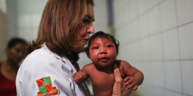 RECIFE, BRAZIL - JANUARY 26: Dr. Angela Rocha (C), pediatric infectologist at Oswaldo Cruz Hospital, examines Ludmilla Hadassa Dias de Vasconcelos (2 months), who has microcephaly, on January 26, 2016 in Recife, Brazil. In the last four months, authorities have recorded close to 4,000 cases in Brazil in which the mosquito-borne Zika virus may have led to microcephaly in infants. The ailment results in an abnormally small head in newborns and is associated with various disorders including decrea