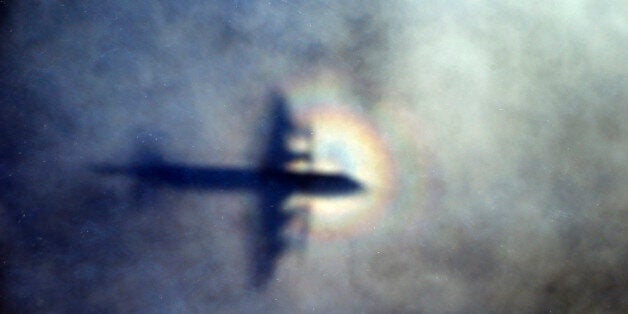 FILE - In this March 31, 2014 file photo, the shadow of a Royal New Zealand Air Force P3 Orion is seen on low level cloud while the aircraft searches for missing Malaysia Airlines Flight MH370 in the southern Indian Ocean, near the coast of Western Australia. Australian authorities said Thursday, Dec. 3, 2015 new analysis confirms they've likely been searching in the right place for a missing Malaysian airliner. (AP Photo/Rob Griffith, File)