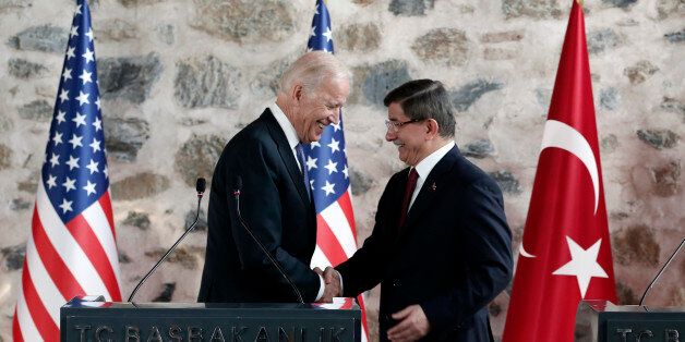 U.S. Vice President Joe Biden, left, shakes hands with Turkish Prime Minister Ahmet Davutoglu, right, following a joint news conference after their meeting in Dolmabahce Palace in Istanbul, Saturday, Jan. 23, 2016. (Sedat Suna/Pool Photo via AP)