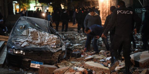 Damaged cars are seen at the scene of a bomb blast in Giza on January 21, 2016.A bomb attack killed six people, including three policemen, on Thursday near a road leading to the pyramids in the Cairo suburb of Giza, security sources said. / AFP / MOHAMED EL-SHAHED / MOY (Photo credit should read MOHAMED EL-SHAHED/AFP/Getty Images)