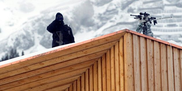 A Swiss police sniper stands on the roof of the Congress Center on January 25, 2011 on the eve of the World Economic Forum annual meeting in Davos. Switzerland has mobilized up to 5,000 soldiers to secure the area surrounding the alpine village of Davos, where world political and economic leaders are to gather this week. AFP PHOTO / JOHANNES EISELE (Photo credit should read JOHANNES EISELE/AFP/Getty Images)