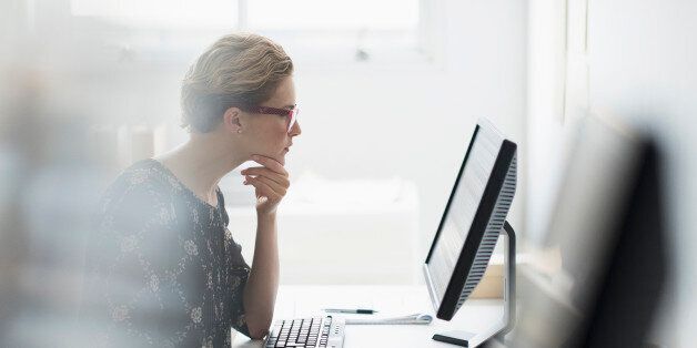 USA, New Jersey, Side view of business woman working on desktop pc in office
