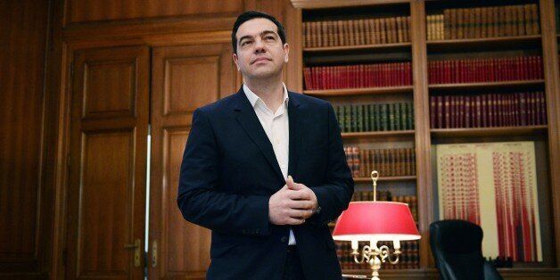 Greek Prime Minister Alexis Tsipras stands in his office in Athens on January 16, 2016, as Germany and Greece signed a joint declaration on tax evasion. / AFP / LOUISA GOULIAMAKI (Photo credit should read LOUISA GOULIAMAKI/AFP/Getty Images)