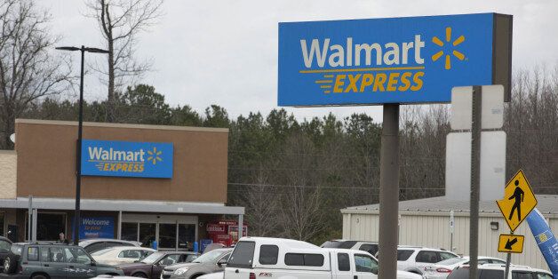 Cars sit parked outside a Wal-Mart Express store in Richfield, North Carolina, U.S., on Friday, Jan. 15, 2016. Wan-Mart Stores Inc. plans to close 269 store, including its experimental small-format Express outlets, in a much to streamline the chain that will eliminate 16,000 jobs. Photographer: Jason E. Miczek/Bloomberg via Getty Images