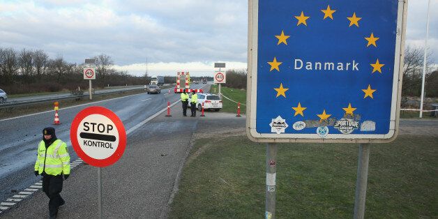 PADBORG, DENMARK - JANUARY 06: Danish police conducting spot checks on incoming traffic from Germany stand at the A7 highway border crossing on January 6, 2016 near Padborg, Denmark. Denmark introduced a 10-day period of passport controls and spot checks yesterday on its border to Germany in an effort to stem the arrival of refugees and migrants seeking to pass through Denmark on their way to Sweden. Denmark reacted to border controls introduced by Sweden the same day and is seeking to avoid a