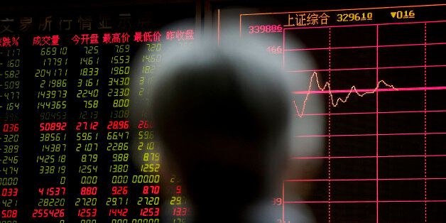 A man looks at an electronic board displaying stock prices at a brokerage house in Beijing, Tuesday, Jan. 5, 2016. Last yearâs Chinese stock boom and disastrous bust has left a legacy of public distrust of financial markets along with a bill the ruling party has yet to disclose for its rescue. The Shanghai index ended 2015 up 9.5 percent for the year, compared with a 0.7 percent loss for Wall Streetâs Standard & Poorâs 500 index. But many novices who bought just before the peak are left with shares worth less than they cost. (AP Photo/Andy Wong)