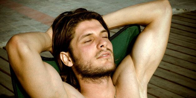 Attractive male is sunbathing
