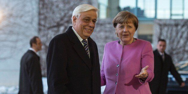 German Chancellor Angela Merkel (R) greets Greek President Prokopis Pavlopoulos prior to talks at the chancellery in in Berlin on January 18, 2016. / AFP / John MACDOUGALL (Photo credit should read JOHN MACDOUGALL/AFP/Getty Images)