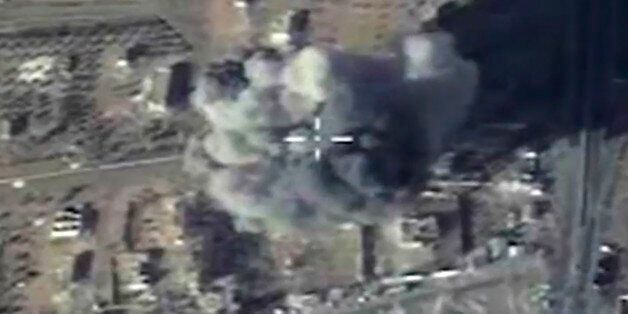 In this photo made from the footage taken from Russian Defense Ministry official web site and provided Wednesday, Dec. 9, 2015 an aerial image shows cruise missile strike on a local ISIS headquarters in Syria. (Russian Defense Ministry Press Service via AP)