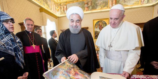 VATICAN CITY, VATICAN - JANUARY 26: Pope Francis exchanges gifts with President of Iran Hassan Rouhani during a private audience at his private library in the Apostolic Palace on January 26, 2016 in Vatican City, Vatican. (Photo by Vatican Pool/Getty Images)