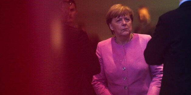 German Chancellor Angela Merkel is surround by staff of the chancellery as she waits for the arrival of the President of Greece Prokopis Pavlopoulos for talks at the chancellery in Berlin, Monday, Jan. 18, 2016. (AP Photo/Markus Schreiber)