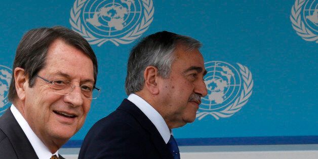 Cyprus president Nicos Anastasiades, left, and Turkish Cypriot leader Mustafa Akinci, centre, and United Nations envoy Espen Barth Eide walk to give a statement to the media after their meeting at the UN-controlled abandoned Nicosia airport on the divided island of Cyprus, Wednesday, Nov. 25, 2015. Eide says intensified talks aimed at reunifying ethnically divided Cyprus have yielded further progress and that the islandâs rival leaders are confident remaining issues can be resolved soon. (AP Photo/Petros Karadjias)