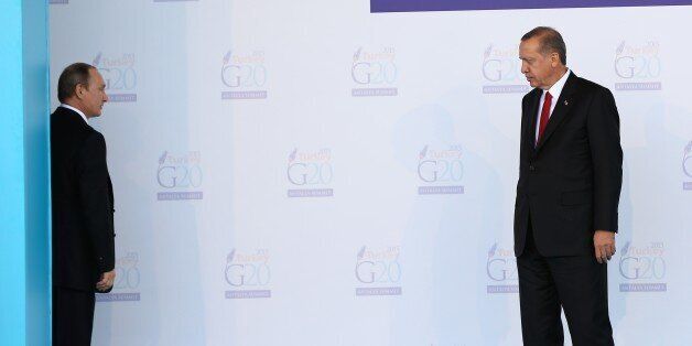 ANTALYA, TURKEY - NOVEMBER 15 : Turkish President Recep Tayyip Erdogan (R) talks with Russian President Vladimir Putin (L) during the 'Welcoming Ceremony' prior to the G20 Turkey Leaders Summit on November 15, 2015 in Antalya, Turkey. (Photo by Turkish Presidency / Yasin Bulbul/Anadolu Agency/Getty Images)