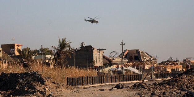 Iraqi military helicopter flies over destroyed houses as security forces clearing the Soufiya neighborhood of Islamic State fighters in central Ramadi, 70 miles (115 kilometers) west of Baghdad, Iraq, Thursday, Jan. 14, 2016. More than two weeks after central Ramadi was decalred liberated, Iraq's counter terrorism forces are slowly battling pockets of Islamic State militants on the northeastern edges. Commanders on the ground say roadside bombs, bobby-trapped houses and the militant group's use