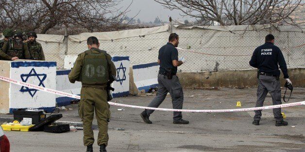 Israeli security forces inspect the scene where a Palestinian was shot dead after attempting to stab...