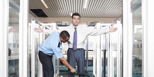 Young businessman annoyed with airport security check. CLICK FOR SIMILAR IMAGES AND LIGHTBOX WITH BUSINESS PEOPLE.