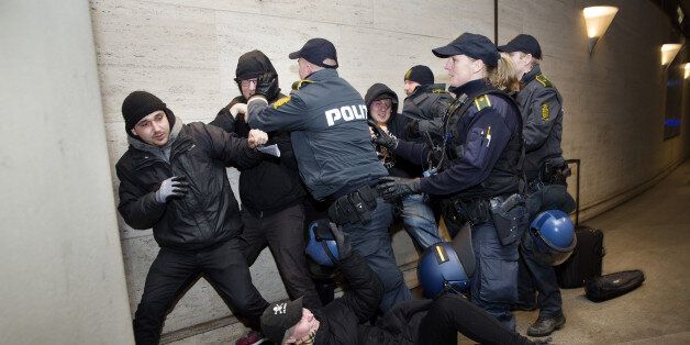 Members of 'Refugees are Welcome' react with police as they demonstrate against the Swedish control of identification from travelers and migrants, at Copenhagen International Airport in Kastrup, Denmark, Saturday, Jan. 9 2016. Sweden requires train companies offering a service across a bridge-and-tunnel link from Denmark to refuse passengers without IDs. (Thomas Borberg/ Polfoto via AP) DENMARK OUT