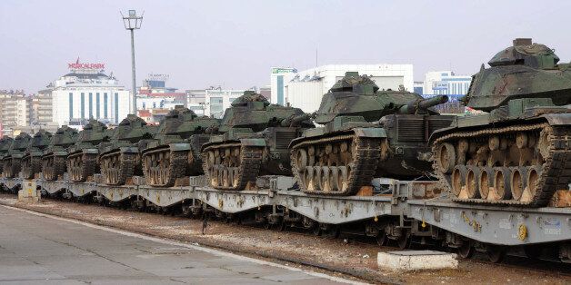 Turkish army tanks are stationed at a train station after their arrival from western Turkey, in Gaziantep, Turkey, Friday, Nov. 27, 2015. Turkey shot down the Russian Su-24 bomber at the Syrian border on Tuesday, insisting it had violated its airspace despite repeated warnings. The tanks are expected to be deployed to the border with Syria. (DHA agency via AP) TURKEY OUT