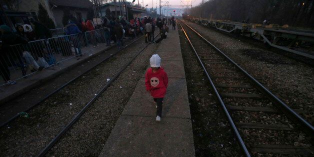 A migrant child walks along the side of railway tracks at the railway station in the southern Serbian town of Presevo, Wednesday, Dec. 23, 2015. As 2015 ends, boat-loads continue to reach the shores of Greek islands from the nearby Turkish coast, while thousands of migrants unlikely to receive refugee status are stranded along the Balkan migrant route, their hopes of reaching the prosperous northern EU countries in jeopardy. (AP Photo/Darko Vojinovic)