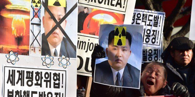 South Korean conservative activists shout slogans with placards showing portraits of North Korean leader Kim Jong-Un during a rally denouncing North Korea's hydrogen bomb test, in Seoul on January 7, 2016. The US and South Korean presidents vowed on January 7 to impose the 'most powerful and comprehensive' sanctions on North Korea after its globally condemned fourth nuclear test. AFP PHOTO / JUNG YEON-JE / AFP / JUNG YEON-JE (Photo credit should read JUNG YEON-JE/AFP/Getty Images)
