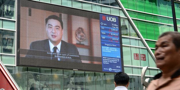 A big screen displays information on the stock index at the Raffles Place financial district in Singapore on January 11, 2016. Asian shares tumbled again on January 11 as another round of tepid data added to concerns about China's economy, which is already responsible for sparking a rout across global markets at the start of the year. AFP PHOTO / ROSLAN RAHMAN / AFP / ROSLAN RAHMAN (Photo credit should read ROSLAN RAHMAN/AFP/Getty Images)