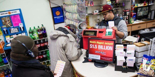 WASHINGTON, USA - JANUARY 13: A customers buy multiple Powerball tickets for the record $1.5 billion jackpot at a convenience store in Gaithersburg, Md., USA on January 13, 2015. (Photo by Samuel Corum/Anadolu Agency/Getty Images)