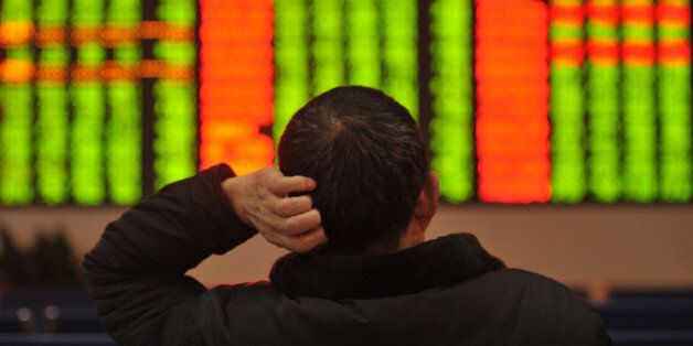 FUYANG, CHINA - JANUARY 04: (CHINA OUT) An investor reacts at a stock exchange hall on January 4, 2016 in Fuyang, Anhui Province of China. Chinese shares slumped to a halt on the first trading day of 2016. The Shanghai Composite Index down 242.52 points, or 6.85 percent, to halt at 3,296.66. The Shenzhen Component Index fell 1,033.95 points, or 8.16 percent, to close at 1,1630.94. (Photo by ChinaFotoPress/ChinaFotoPress via Getty Images)