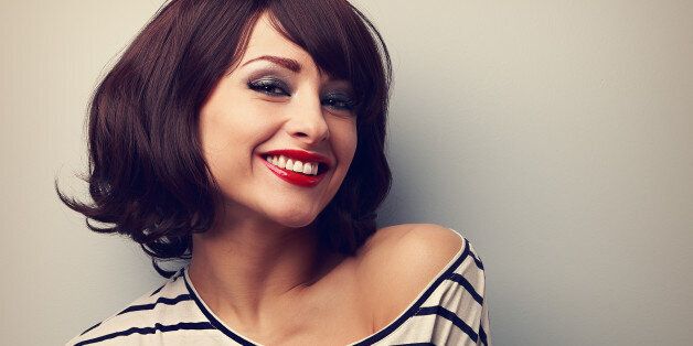 Happy laughing young woman with short hair in fashion blouse. Vintage closeup portrait