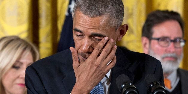 President Barack Obama wipes away tears from his eyes as he recalled the 20 first-graders killed in 2012 at Sandy Hook Elementary School, while speaking in the East Room of the White House in Washington, Tuesday, Jan. 5, 2016, about steps his administration is taking to reduce gun violence. Also on stage are stakeholders, and individuals whose lives have been impacted by the gun violence. (AP Photo/Carolyn Kaster)