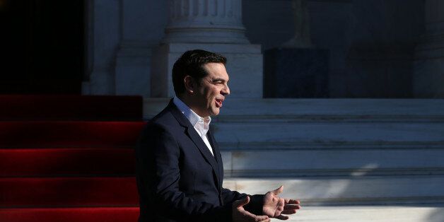Greek Prime Minister Alexis Tsipras, gestures during the arrival of the Palestinian President Mahmoud Abbas before their meeting in Athens, on Monday, Dec. 21, 2015. Abbas is in Greece on a two-day official visit. (AP Photo/Petros Giannakouris)