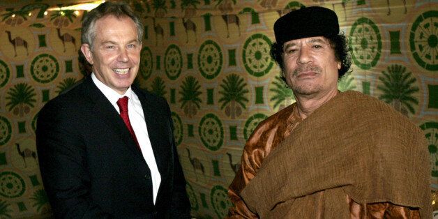 FILE - In this May 29, 2007 file photo, Britain's Prime Minister Tony Blair, left, meets Libyan leader Moammar Gadhafi, at his desert base outside Sirte south of Tripoli. Former British Prime Minister Tony Blair says he has personally urged Libyan leader Moammar Gadhafi to step down and set up a transitional government to prevent further violence in the North African nation. (AP Photo/Leon Neal, Pool-File)
