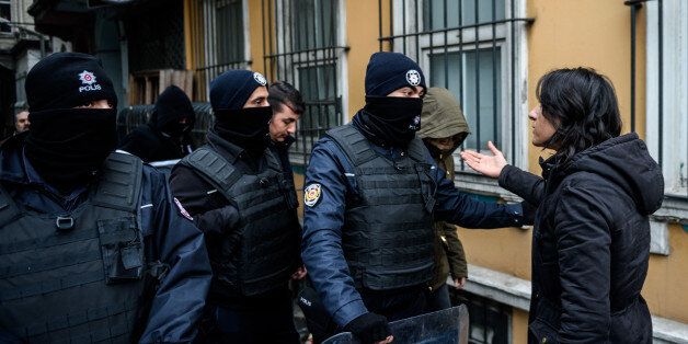 Turkish riot police block the street as a pro-Kurdish Peoples' Democratic Party (HDP) Beyoglu member tries to enter the offices during a police search of their headquarters on January 8, 2016 in Istanbul.A Turkish court on January 4, sentenced a co-mayor of a major city in the Kurdish-majority southeast to 15 years in jail on charges of membership of the outlawed Kurdistan Workers Party (PKK). / AFP / OZAN KOSE (Photo credit should read OZAN KOSE/AFP/Getty Images)