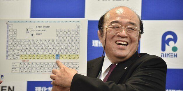 Kosuke Morita, the leader of the Riken team, smiles as he points to a board displaying the new atomic element 113 during a press conference in Wako, Saitama prefecture on December 31, 2015. A Japanese research team has received naming rights for new atomic element 113, the first on the periodic chart to be named by Asian scientists, the team's institute said December 31. Japan's Riken Institute said a team led by Kosuke Morita was awarded the rights from global scientific bodies -- the International Union of Pure and Applied Chemistry (IUPAC) and the International Union of Pure and Applied Physics (IUPAP) -- after successfully creating the new synthetic element three times from 2004 to 2012. AFP PHOTO / KAZUHIRO NOGI / AFP / KAZUHIRO NOGI (Photo credit should read KAZUHIRO NOGI/AFP/Getty Images)