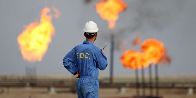 An Iraqi labourer works at an oil refinery in the southern town Nasiriyah on October 30, 2015. South Oil Company (SOC) has raised production at Nasiriyah oil field from 40,000 barrels per day to between 65,000 and 70,000 barrels as it aims to reach 100,000 barrels by the end of next month. AFP PHOTO / HAIDAR MOHAMMED ALI / AFP / HAIDAR MOHAMMED ALI (Photo credit should read HAIDAR MOHAMMED ALI/AFP/Getty Images)