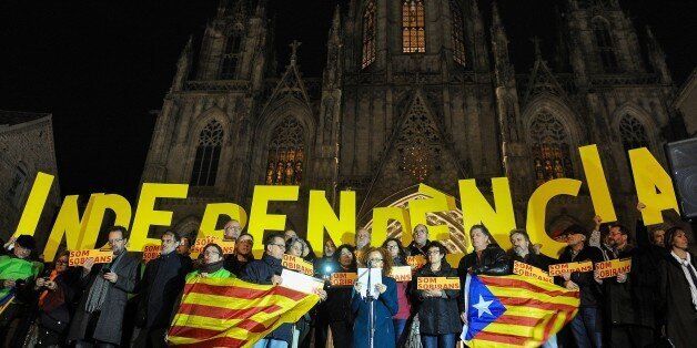 Demonstrators hold big letters forming the word 'Independence' during a demonstration called by the Catalan National Assembly (ANC) demanding an agreement between secessionist parties in Barcelona on January 7, 2016. Catalonia's outgoing separatist leader Artur Mas said on December 5, 2016 he was reluctantly 'ready' to call fresh parliamentary elections, with the Spanish region's secessionist faction unable to agree on who should lead a new government after winning September's polls. AFP PHOTO