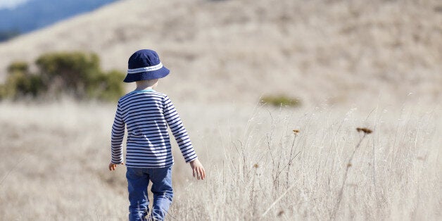 little boy enjoying beautiful weather alone outdoors