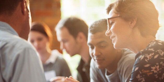 Business people sharing digital tablet in meeting