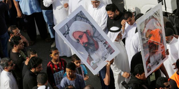 In this Saturday, May 30, 2015, photo, Saudis carry a poster demanding freedom for jailed Shiite cleric Sheikh Nimr al-Nimr, during a funeral procession, in Tarut, Saudi Arabia. Saudi Arabia says it has executed 47 prisoners, including leading Shiite cleric Sheikh Nimr al-Nimr. The clericâs name was among a list of the 47 prisoners executed carried by the state-run Saudi Press Agency. It cited the Interior Ministry for the information. (AP Photo/Hasan Jamali)
