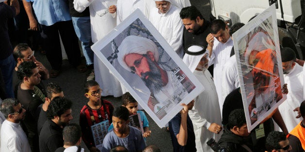 In this Saturday, May 30, 2015, photo, Saudis carry a poster demanding freedom for jailed Shiite cleric Sheikh Nimr al-Nimr, during a funeral procession, in Tarut, Saudi Arabia. Saudi Arabia says it has executed 47 prisoners, including leading Shiite cleric Sheikh Nimr al-Nimr. The clericâs name was among a list of the 47 prisoners executed carried by the state-run Saudi Press Agency. It cited the Interior Ministry for the information. (AP Photo/Hasan Jamali)