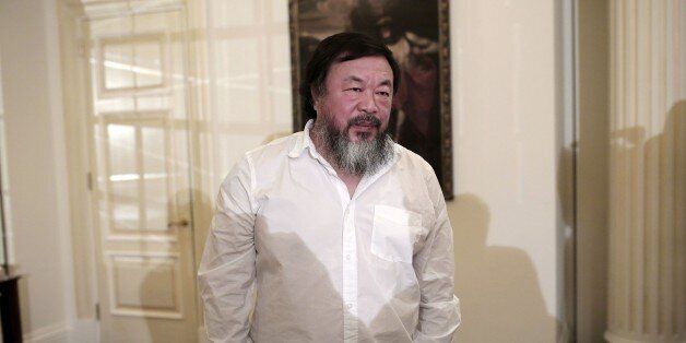 Chinese activist and artist Ai Weiwei waits before a press conference in Athens on January 1, 2016. Chinese dissident artist Ai Weiwei paid on December 28, 2015 a holiday visit to refugees and migrants flocking to the Greek island of Lesbos, tweeting out photos and videos in appeals for their plight. / AFP / ANGELOS TZORTZINIS (Photo credit should read ANGELOS TZORTZINIS/AFP/Getty Images)