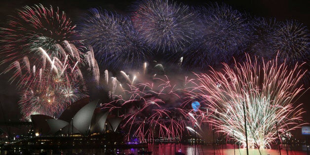 Fireworks explode over the Opera House and the Harbour Bridge during New Years Eve celebrations in Sydney, Australia, Thursday, Jan. 1, 2015. Thousands of people crammed into Lady Macquaries Chair look-out to see the new year in and watch the annual fireworks show. (AP Photo/Rob Griffith)